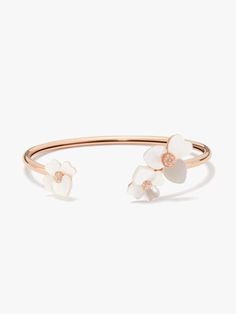 handcrafted of rose gold-tone metal and mother-of-pearl shell our precious pansy collection is true to its name. and this flex cuff is designed with lots of thoughtful details: like the sparkly crystal centers and heart-shaped petals. did you notice the larger ones? they're a nod to our signature mark. | Kate Spade Precious Pansy Flex Cuff, Cream/Rose Gold Spring Formal Rose Gold Jewelry, Elegant Rose Gold Bracelets For Spring, Elegant White Kate Spade Bracelet, Spring Gift Jewelry By Kate Spade, Kate Spade Rose Gold Bracelet Gift, Kate Spade Rose Gold Bracelets For Gift, Pink Frames, Open Bangle, Gold Bracelet Cuff