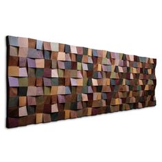 a large wooden wall sculpture with many different colored squares on it