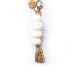 a keychain with a white tassel hanging from it's side on a white background