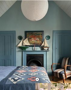 a bed room with a neatly made bed next to a fire place and a painting on the wall