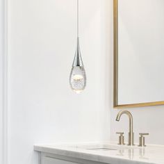 a bathroom with a sink, mirror and light fixture hanging from the ceiling above it