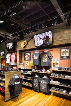 the inside of a sports shop with t - shirts and other items on display in wooden shelves