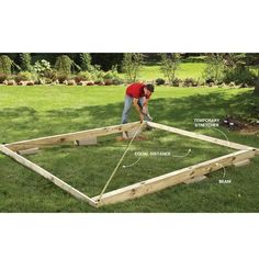 a man is working on building a garden bed in the yard with measurements and instructions