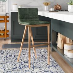 a bar stool sitting on top of a blue and white rug next to a counter