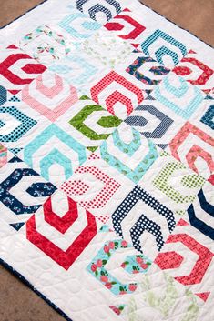 a colorful quilt with letters on it