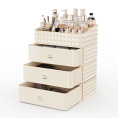 three drawers are stacked on top of each other with different types of cosmetics in them