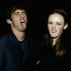 two people standing next to each other with their mouths open and one person sticking his tongue out