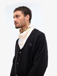 Boxy fit button-up cardigan in merino wool and cashmere, tone-on-tone embroidered logo at front, black and gold button closure, ribbed collar, cuff, and hem, and signature black leather badge at back. -Body: 70% Merino Wool / 30% Cashmere -Color: Black -Boxy Fit -Model is 6'0'' / 183cm and wears M -Care: Dry clean only -Made in Italy Luxury Black Sweater With Button Closure, Luxury Sweater With Button Closure For Formal Occasions, Luxury Cardigan For Workwear, Luxury Cardigan With Ribbed Cuffs, Luxury Formal Cardigan With Button Closure, Luxury Fall Cardigan, Luxury Winter Cardigan With Button Cuffs, Luxury Black Cardigan For Formal Occasions, Luxury Black Formal Cardigan