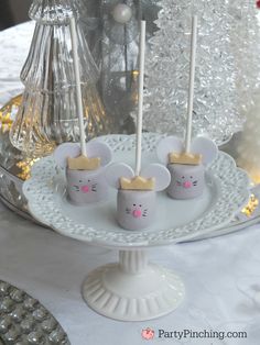 cake pops decorated with mouse heads on a white plate