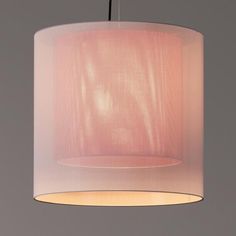 a pink lamp shade hanging from a ceiling