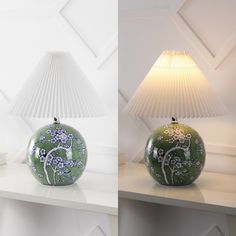 two vases sitting on top of a white shelf next to a lampshade