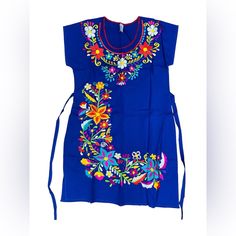 Flattering Mini Dress Made In Thick And Soft Cotton Manta Fabric With Beautiful Silk Thread Floral Embroidery, It Comes With Back Straps For A Better Fit. The Photo Is A Representation Of The Color And Style But The Dress You Will Actually Rerceive May Vary In Patterns And Colors. Traditional Blue Dress With Embroidered Hem, Traditional Blue Embroidered Dress With Embroidered Hem, Traditional Blue Dress With Embroidered Neckline, Blue Floral Embroidery Dress For Beach, Traditional Blue Embroidered Dress With Floral Details, Blue Dresses With Embroidered Hem, Traditional Blue Dress With Floral Embroidery, Traditional Blue Sleeveless Dress, Blue Floral Embroidered Dress For Beach