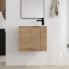 a bathroom with a sink, mirror and towel hanging on the wall next to it