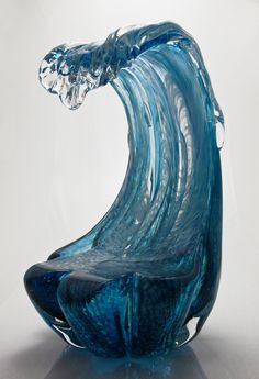 a blue glass sculpture sitting on top of a table