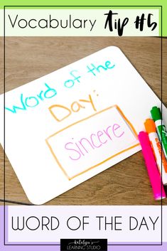 the word of the day is written on a piece of paper with crayons next to it