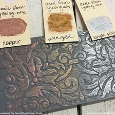 three different types of spices on top of a wooden table next to paper with writing