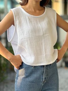 "Elevate your summer style with this breezy Muslin Double Gauze Sleeveless Crop Top Tank Blouse. Crafted from lightweight, breathable cotton muslin, this top is a perfect blend of comfort and chic. The double gauze fabric adds a touch of texture and an extra layer of softness, ensuring you stay cool and comfortable even on the hottest days. Its sleeveless design and cropped silhouette make it ideal for pairing with high-waisted shorts or skirts, offering a flattering fit for any body type. The blouse features a relaxed, airy fit that moves with you, and a classic round neckline that complements the minimalist aesthetic. Whether you're heading to a picnic, a casual day out, or a beach getaway, this versatile tank top is a must-have addition to your warm-weather wardrobe. Bust 40\" Length 20 Beach Getaway, Double Gauze Fabric, Gauze Fabric, Cotton Muslin, Top Tank, Double Gauze, Sleeveless Crop Top, Minimalist Aesthetic, Muslin Cotton