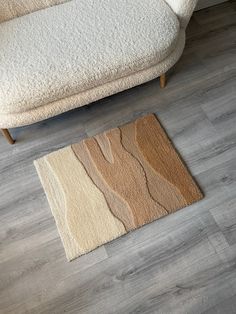 a white couch sitting on top of a hard wood floor next to a wooden floor