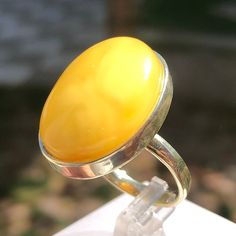 Handmade Yellow Amber Ring 10,1 Grams in 925 Sterling Silver.  Adjustable Size Ring.  Unique and fashionable ring from Czech Republic. It is made of genuine yellow baltic amber with the highest level of quality silver. It is very elegant jewelry. It is adjustable and suits to everyone. Our all products are made with passion and our customers in mind. Classic Yellow Sterling Silver Rings, Yellow Polished Ring Jewelry, Yellow Rings With Polished Finish For Anniversary, Elegant Yellow Cabochon Rings, Yellow Polished Finish Ring, Anniversary Yellow Rings With Polished Finish, Classic Yellow Jewelry With Polished Finish, Yellow Sterling Silver Ring With Gemstone, Classic Yellow Rings With Polished Finish