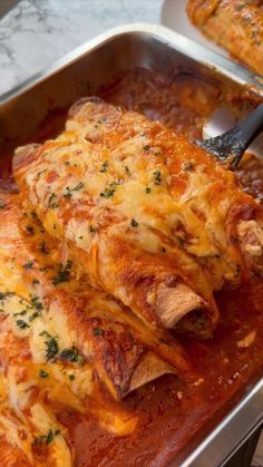 a pan filled with meat covered in sauce and cheese