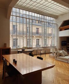 a living room with wooden floors and large windows