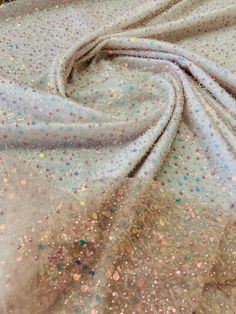 the fabric is covered with multicolored sequins