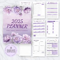 the 2021 planner is shown with purple flowers on it and two sheets of paper next to it