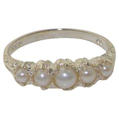 This stunning ring is made from 14K White Gold fitted with Cultured Freshwater Pearls. Beautifully Handcrafted from Solid English 14K White Gold and Tested and Hallmarked by the London Assay Office. The Hallmark includes the 585 marking plus the Leopard's Head and the Royal Crown. The Pearls are Freshwater Cultured Pearls that are hand selected and hand set. The pearls measure 4 mm, 3 mm & 2.75 mm (0.16",0.12" & 0.11" inches) If you know your US, UK, Australian or European Finger Size then please include this as a note attached to your order otherwise we will work to the size you have selected. CUSTOMIZE THIS RING This ring can be customized to your requirements - 9K, 10K, 14K, or 18K in Yellow, Rose or White Gold or Platinum and whatever stone combination you would like. If I don't have t Vintage White Gold Ring, Pearl Wedding Ring Vintage, Pearl Wedding Bands, Regency Wedding, Pearl Rings Vintage, Flower Rings, Pearl Vintage, Half Eternity Band, Crown Ring