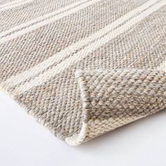 a close up view of a rug on a white surface with no one in it