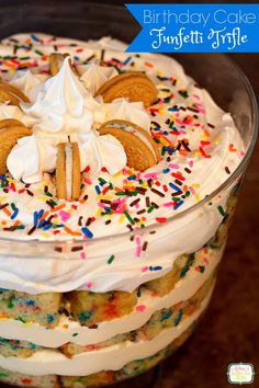 a dessert with white frosting, sprinkles and cookies on top is in a glass dish