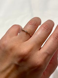 Details: Gemstone: Natural Cubic Zirconia, Brilliant Cut, 2mm Band: 14k gold filled, 18 gauge wire (1.09mm thick) The Ring size is 5 (US). Only this size is available for now.   A perfect gift for someone special or yourself. This beautiful dainty ring is the perfect tiny gemstone stacker.  This listing is for ONE ring. Perfect ring for everyday wear.  Each piece is handcrafted and made-to-order, specifically for you. Although I do my best to get orders out as quickly as possible. April Birthstone Ring, Zierlicher Ring, April Birthstone, Ring Stacking, Cubic Zirconia Rings, Ring Dainty, One Ring, Jewelry Inspo, Dainty Ring