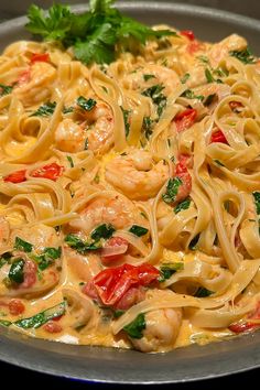 pasta with shrimp, tomatoes and parsley in a pan