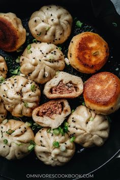 some dumplings are cooking in a pan with sauce and seasoning on them,