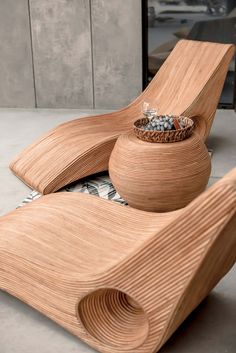 two wooden bowls sitting next to each other on top of a table with rocks in them