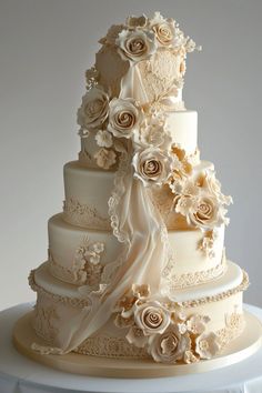 a three tiered wedding cake with white flowers