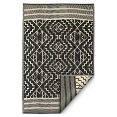 two black and white rugs on top of each other, one with an intricate design