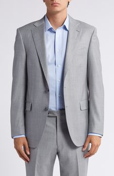 a man in a gray suit and blue shirt