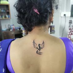 a woman with a tattoo on her back