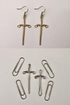 three different types of paper clips and binders on a white surface, one with a crucifix in the middle