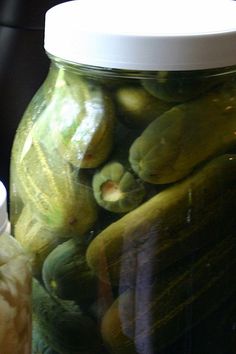 pickles and other vegetables in a glass jar