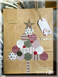 a brown paper bag with a christmas tree on it and tags hanging from the handles