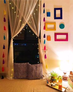 a living room filled with lots of furniture next to a window covered in curtains and tassels