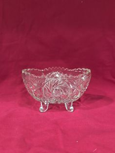 a clear glass bowl on a pink background