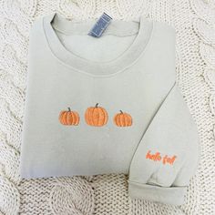 Celebrate the spirit of the season with our Embroidered Pumpkin Sweatshirt and Halloween Sweatshirt. Embrace the cozy charm of fall and the enchantment of spooky moments. Whether it's for yourself or a loved one, our Embroidered Crewneck is the perfect gift for those who cherish warmth and love. 🎈 Product Details - T- Shirt: 5.3 oz., 100% preshrunk cotton - Sweatshirt : 8 oz., 50% USA cotton, 50% polyester - Hoodie: 8 oz., 50% USA cotton, 50% polyester 🎈 Sizing and Coloring - Our top-selling s Pumpkin Embroidery Shirts, Fall Sweatshirt With Embroidered Graphics, Fall Cotton Sweatshirt With Embroidered Graphics, Cotton Sweatshirt With Embroidered Graphics For Fall, Fall Long Sleeve Sweatshirt With Custom Embroidery, Fall Crew Neck Sweatshirt With Custom Embroidery, Fall Embroidered Graphics Sweatshirt With Relaxed Fit, Fall Embroidered Graphics Sweatshirt In Relaxed Fit, Embroidered Long Sleeve Sweatshirt For Fall