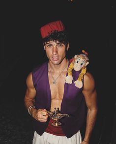 a man in costume holding a stuffed animal