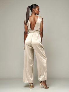 This soft satin jumpsuit features a flattering v-neck design, making it the perfect choice for mothers of the bride. Its dress pantsuit style provides comfort and elegance, while its high-quality material ensures a polished look. Stay stylish and comfortable on that special day with our jumpsuit. Chic Satin V-neck Jumpsuits And Rompers, Elegant V-neck Spring Pantsuit, Chic Sleeveless Satin Jumpsuit, Sleeveless Satin Jumpsuit Or Romper, Sleeveless Satin Jumpsuits And Rompers, Sleeveless Solid Color Satin Jumpsuits And Rompers, Formal Satin V-neck Jumpsuit, Elegant Satin Jumpsuit Or Romper In Solid Color, Chic Satin Jumpsuits And Rompers With V-neck