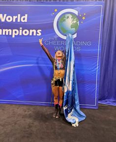 a woman standing in front of a blue banner with the words world championships on it