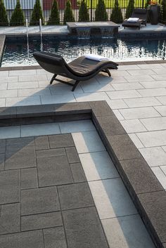 a lounge chair sitting in front of a swimming pool