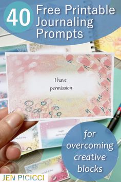 a person holding up a card with the text 40 free printable journaling prompts for overcoming creative blocks