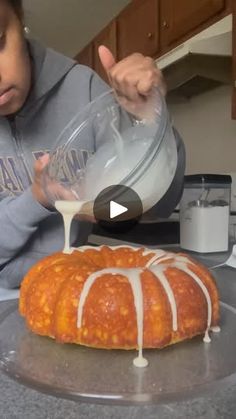 a person pouring glaze on a bundt cake